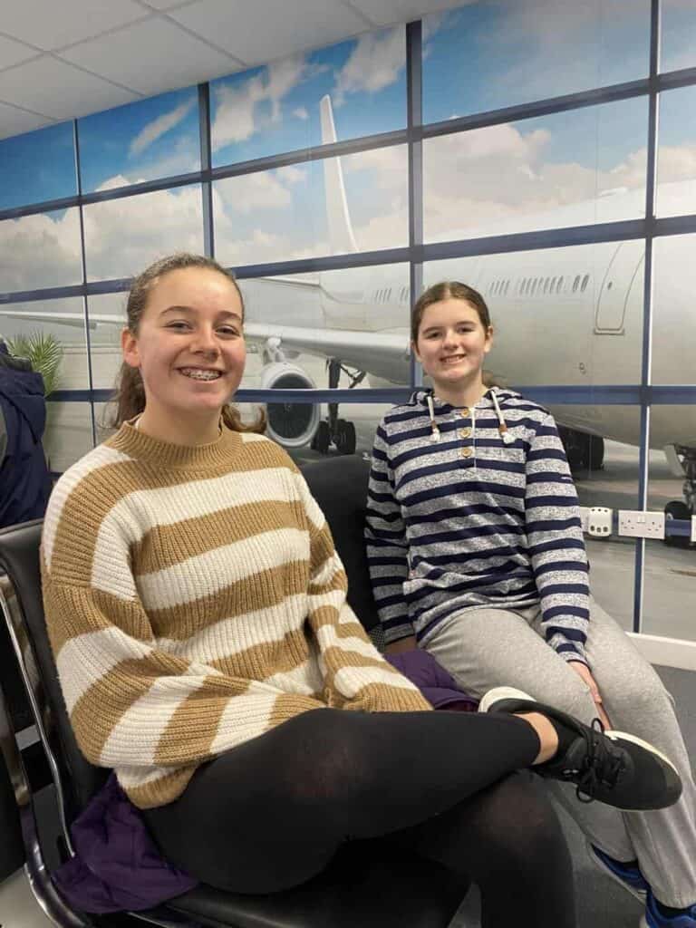 Girls sitting in the mock departure gate at Flyme in Barnsley ready for the aviation career day 
