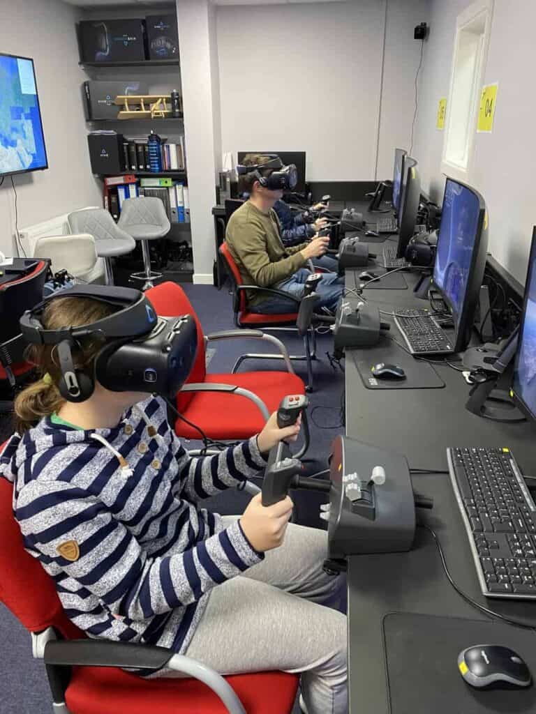Peggy and Dom are now sat with headsets on for the full virtual experience of flying a plane as part of the aviation career day