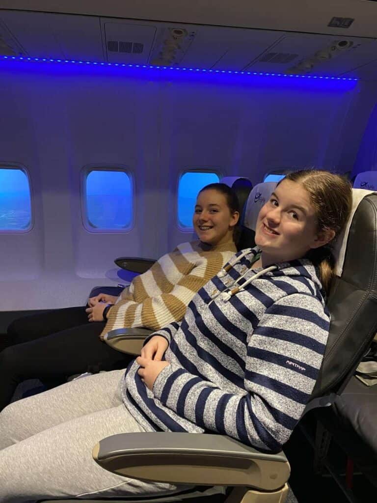 Peggy and Aggie are passengers on the plane being piloted by Susan on the aviation career day 